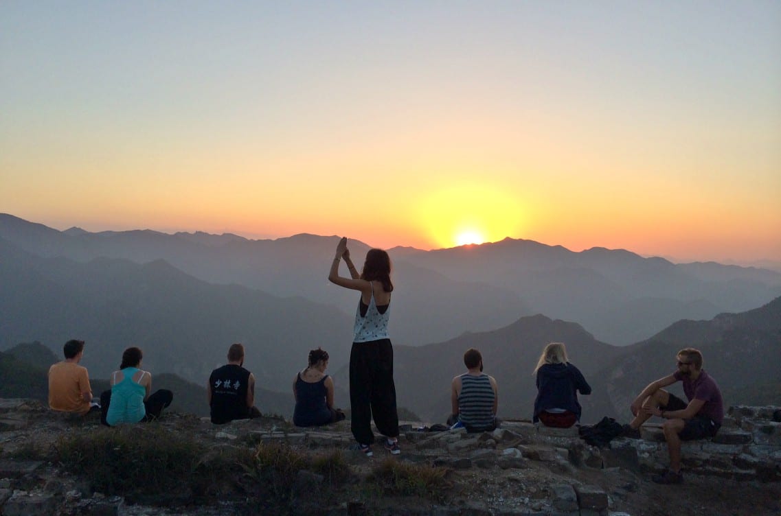 Watching the sunrise from the Great Wall of China on a China group tour