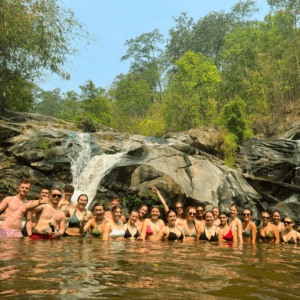 group swimming in waterfalls in cambodia